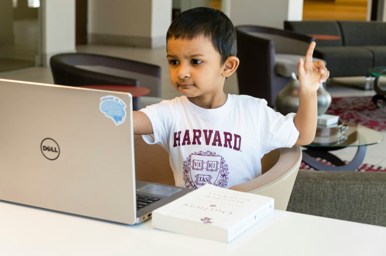 An Indian boy working through maths on a laptop at home
